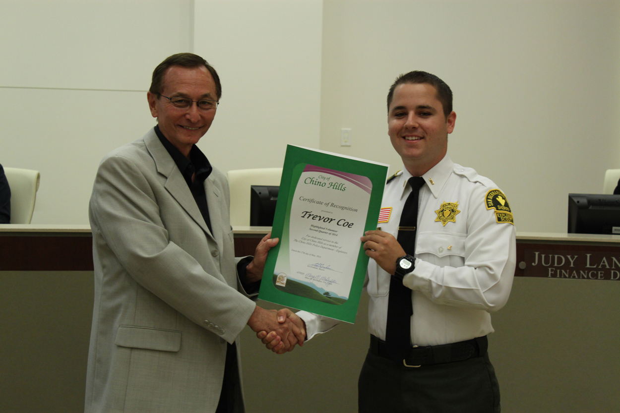 Photo of Trevor Coe, Highlighted Volunteer of the Quarter and Mayor Graham